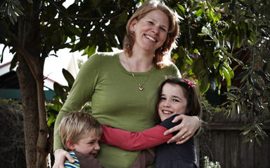 Lisa and her 2 children smiling and hugging.
